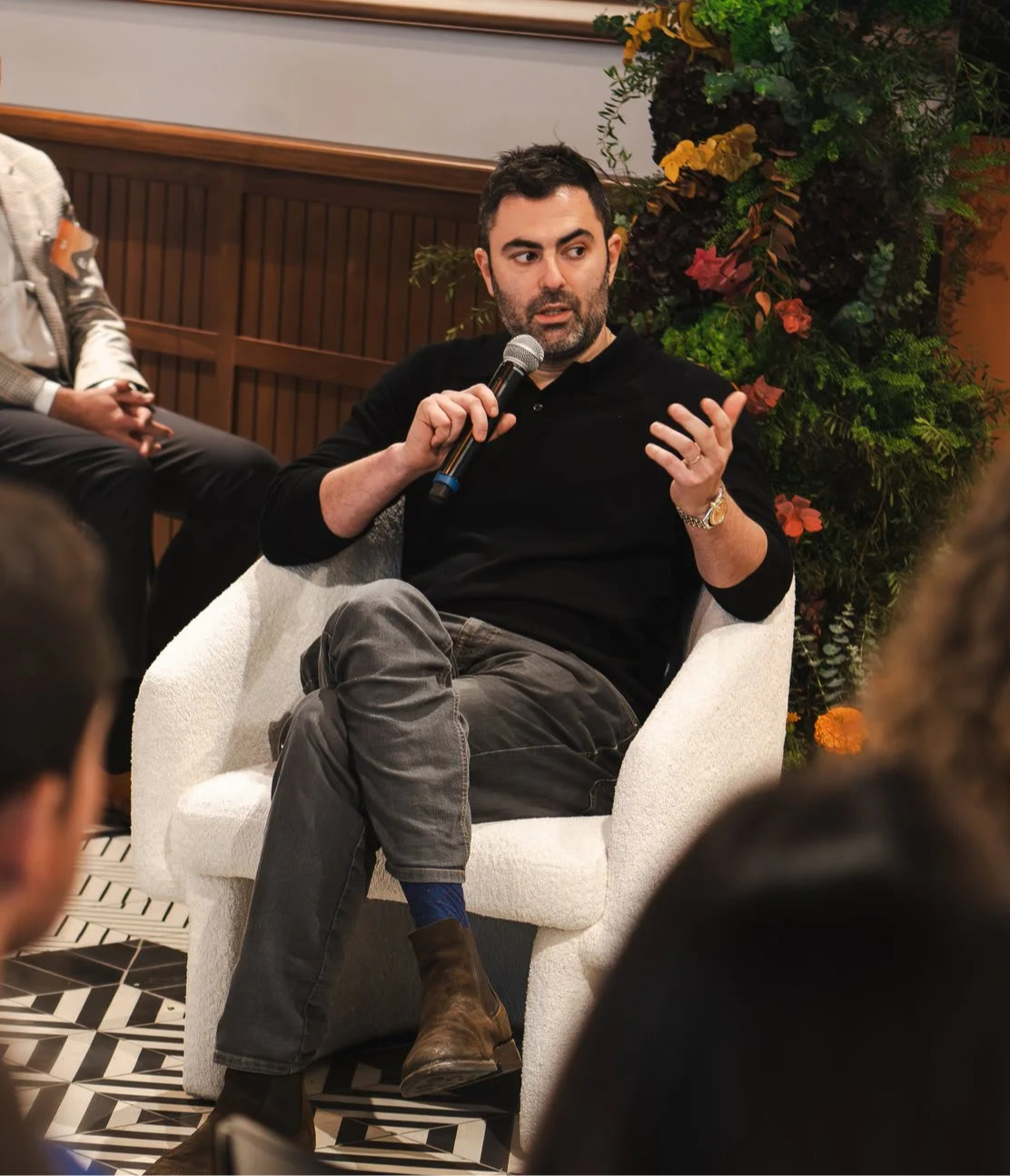 Eric Markowitz speaking on stage with a microphone